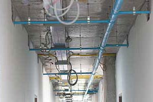 Ceiling of industrial area showing pipes. New Construction Commercial Plumbing in Portland OR by D & F Plumbing
