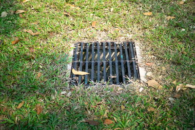 Drain in the middle of a yard. D&F Plumbing, Heating and Cooling provides area drain cleaning services in the Portland, OR and Vancouver, WA areas.