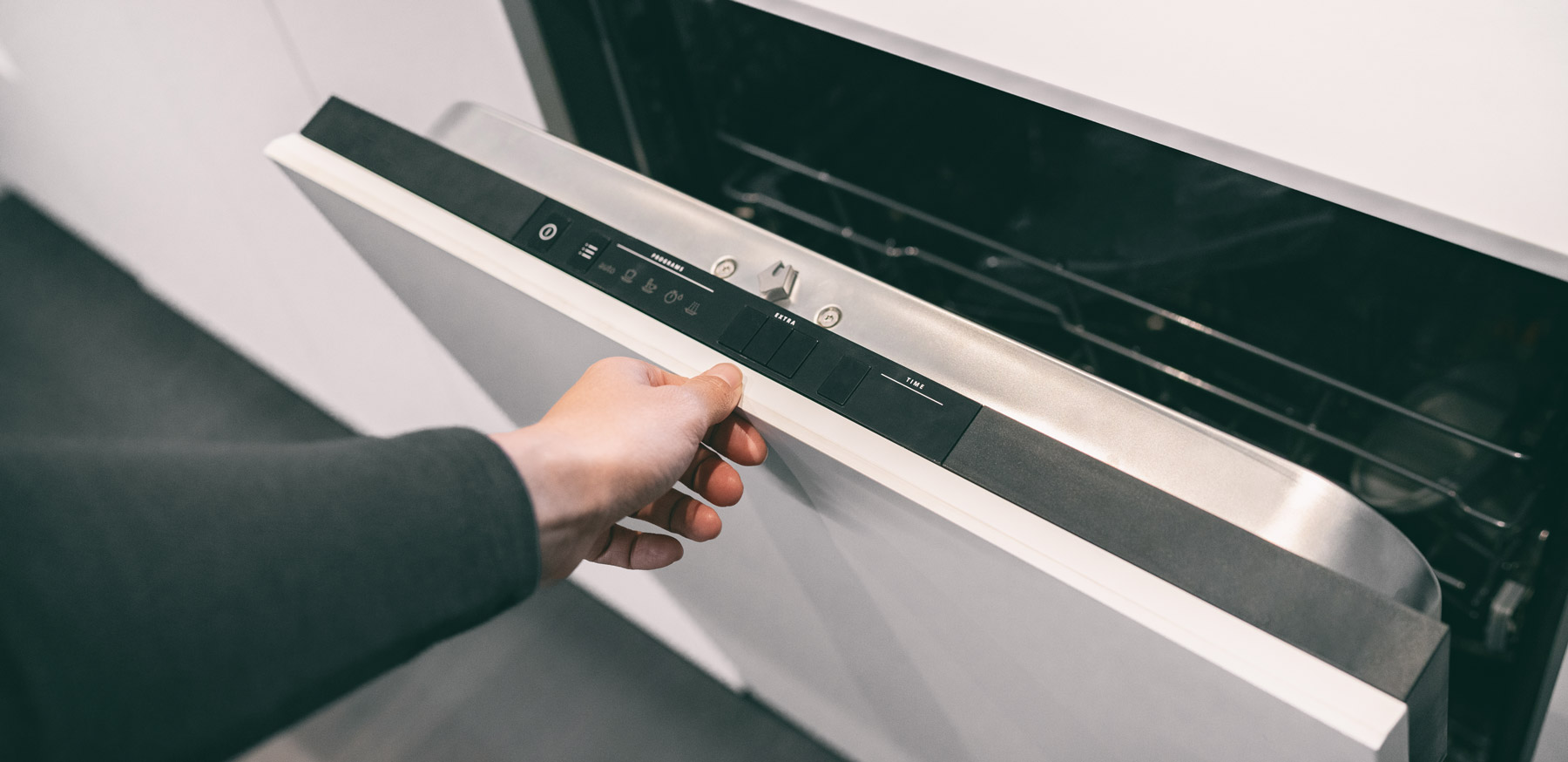 Person opening dishwasher door. D & F Plumbing provides quality appliance installation services in Portland OR & Vancouver WA.