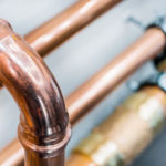 Up close of copper piping. D&F Plumbing, Heating and Cooling serving Portland OR and Vancouver WA reveals ways to determine if it's time to replace your home's plumbing.
