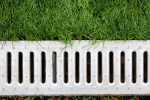 Channel drain in lawn. D&F Plumbing, Heating and Cooling in Portland OR & Vancouver WA talks about how to drain water from your yard.