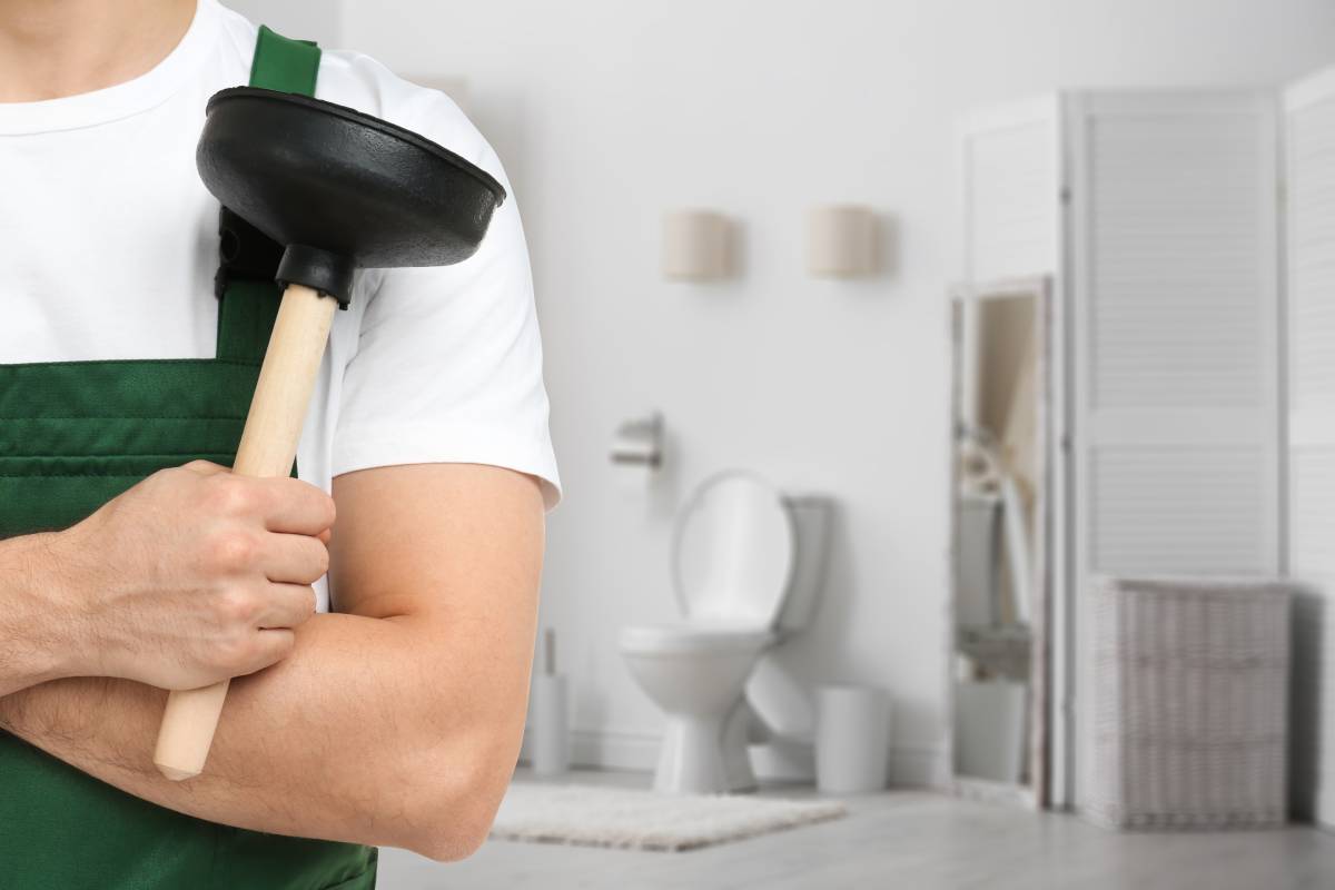 Plumber holding a toilet plunger