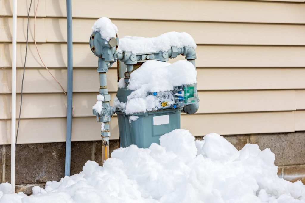 Gas meter outside home covered in snow