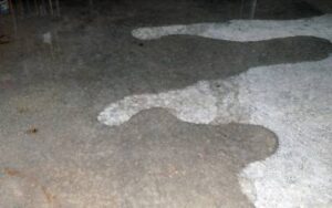 Water leaking on foundation slab in basement