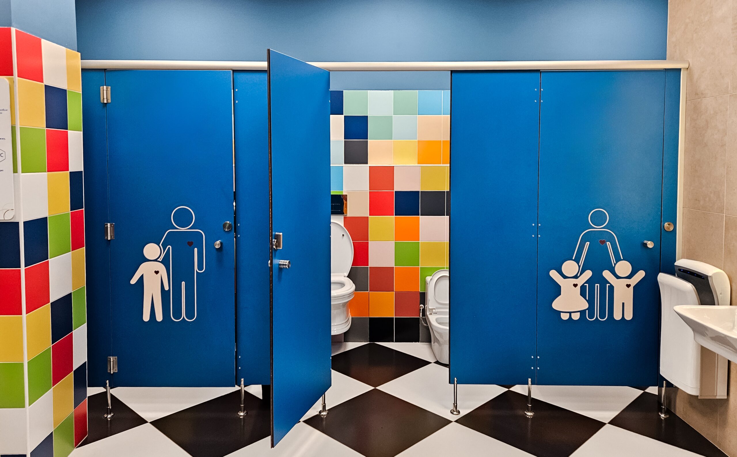 Shared family bright restroom in airport, mall Unisex WC for mom, dad,little girl boy,child kid Use together Recreation room, toilet for adults, daughter,son Separate cabins for parents,children