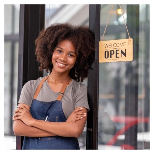 store owner smiling outside of shop