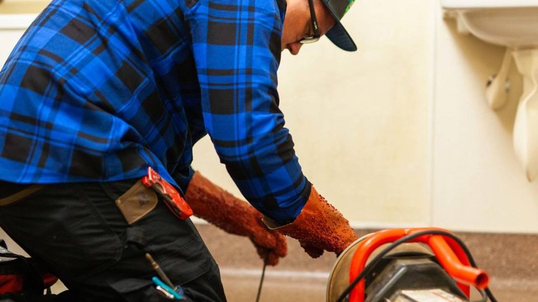 D&f technician clearing a drain