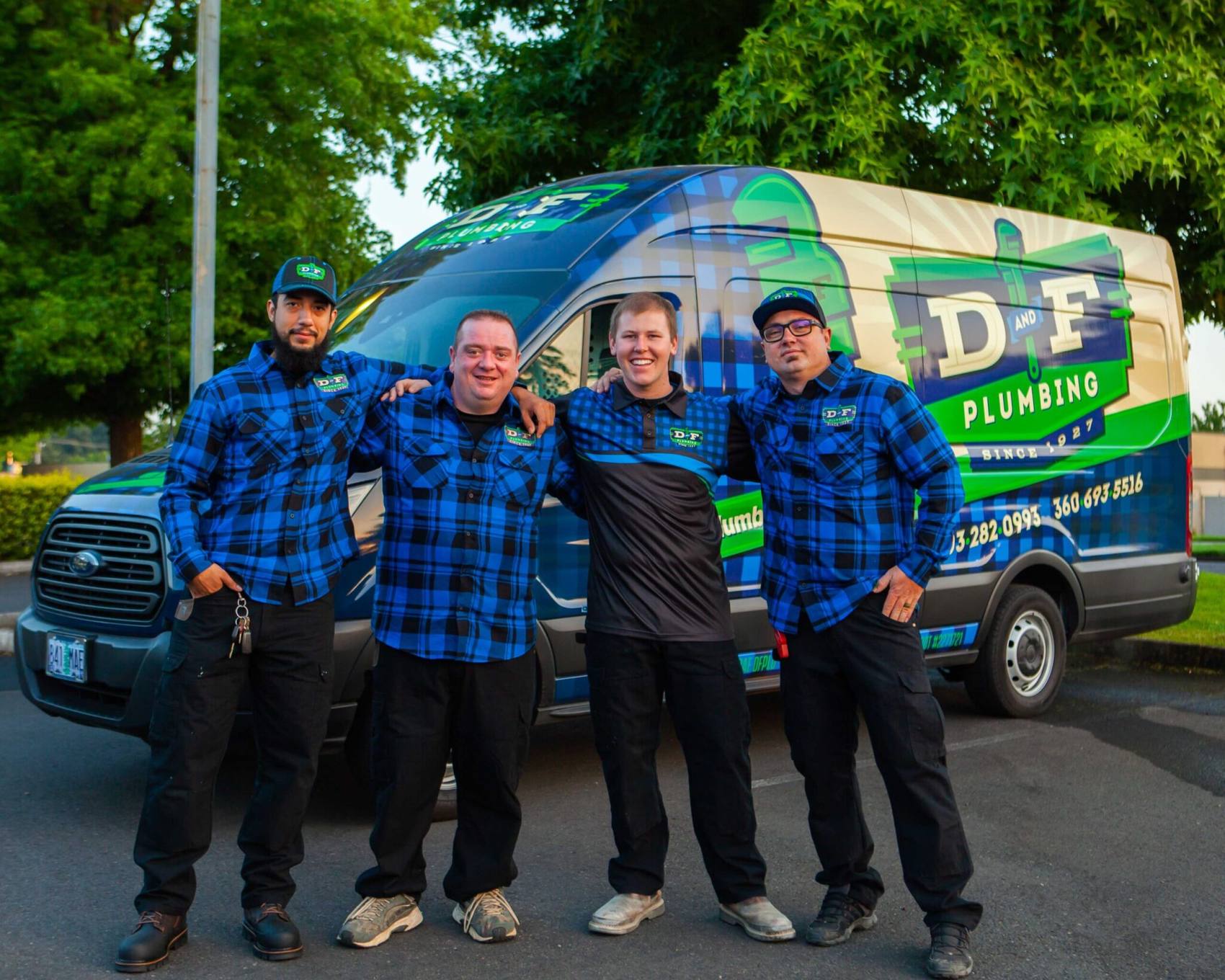 D&f plumbing crew in front of a service van