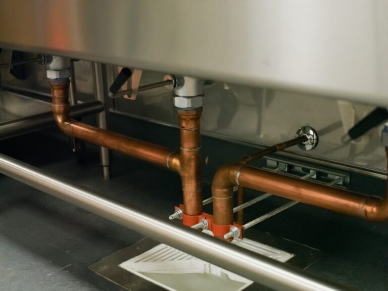 Copper indirect waste piping from a restaurant sink to a floor sink