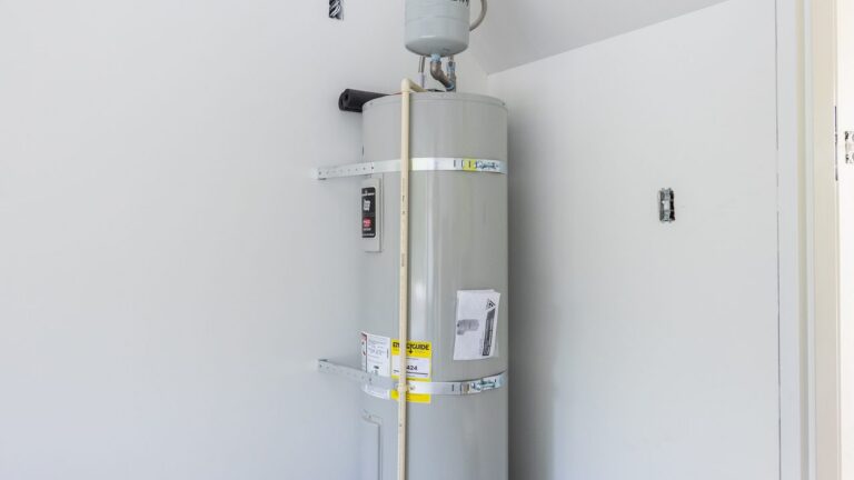 Electric tank water heater installed by D&F in a utility closet