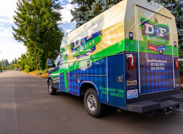 D&F Plumbing, Heating and Cooling service truck on a neighborhood street